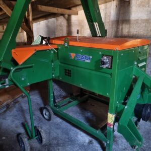 Orange and green Posch kindling machine in shed